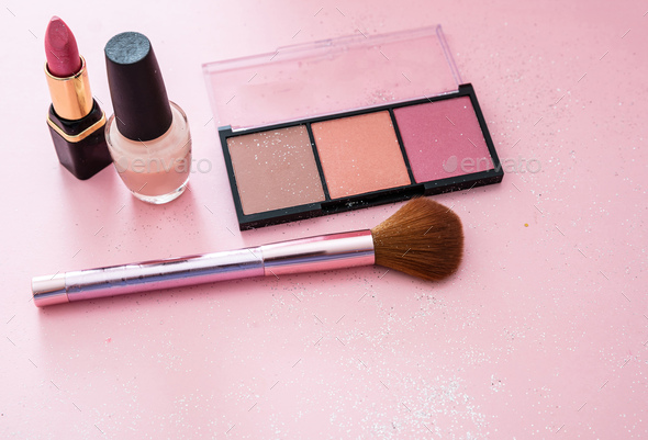 Blush powder and brush, lipstick and nail polish against pink background - Stock Photo - Images