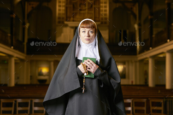 nun in church with rosary and bible - Stock Photo - Images