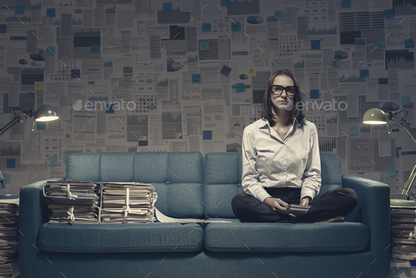 Businesswoman working on the sofa late at night - Stock Photo - Images