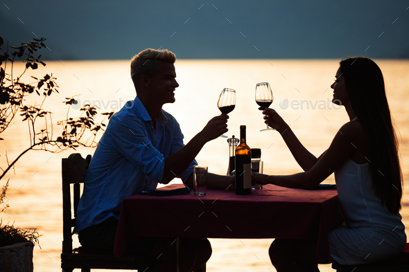 Happy couple on summer evening having romantic dinner outdoor Stock Photo  by nd3000