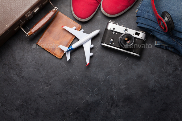 Suitcase, camera, clothes and travel accessories - Stock Photo - Images