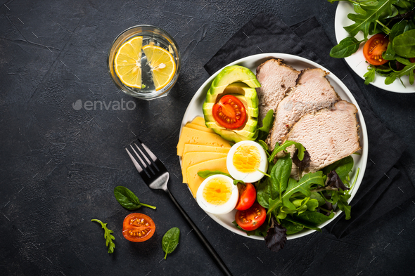 Keto diet plate on black stone table - Stock Photo - Images