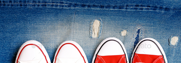 Banner with White and red sneakers on a the ripped denim background.