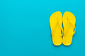 Yellow Beach Flip-Flops On The Blue Background - PhotoDune Item for Sale