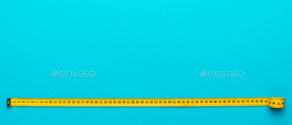 Top View Of Yellow Measuring Tape Over Turquoise Blue Background With Copy Space - Stock Photo - Images