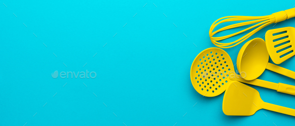 Download Yellow Plastic Kitchen Utensils Over Turquoise Blue Background With Copy Space Stock Photo By Garloon PSD Mockup Templates