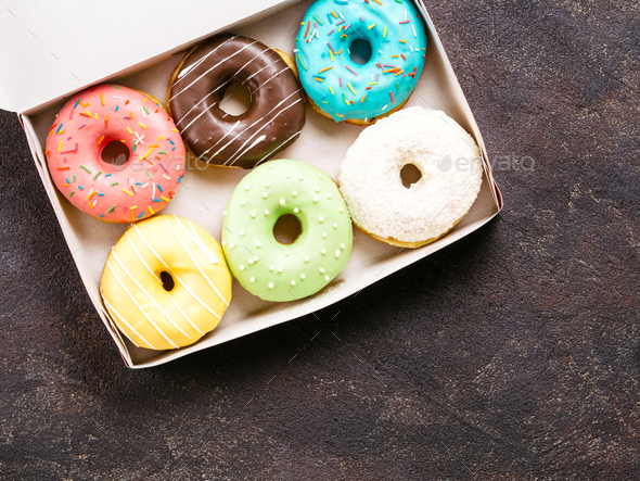 paper box with colorful donuts, top view, copy space
