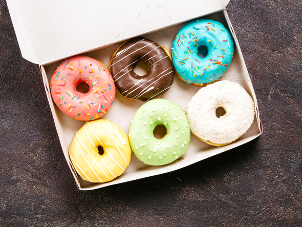 paper box with colorful donuts, top view, copy space