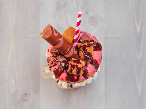 Freakshake with donuts on gray wooden background - Stock Photo - Images