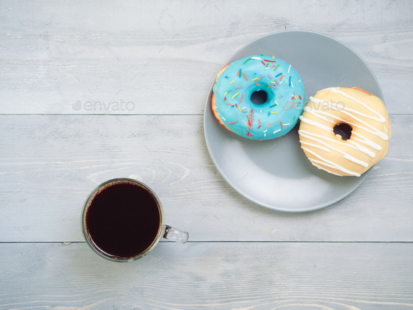 donuts and coffee on gray wooden background, copy space, top view - Stock Photo - Images