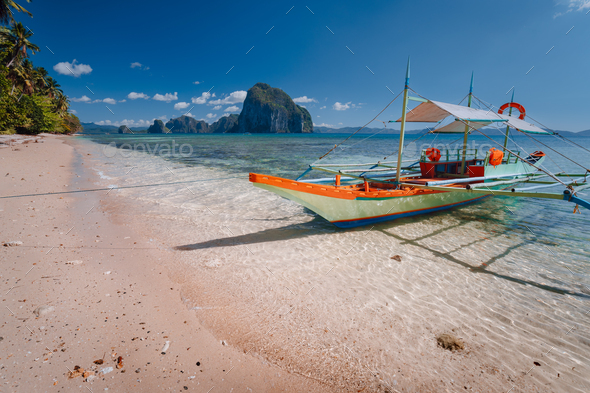 Tourist banca boat on beach ready for island hopping with beautiful scenery of surreal Pinagbuyutan - Stock Photo - Images