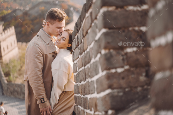 beautiful young couple hugging at the Great Wall of China - Stock Photo - Images