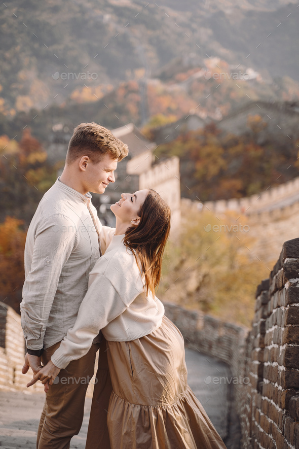beautiful young couple hugging at the Great Wall of China - Stock Photo - Images