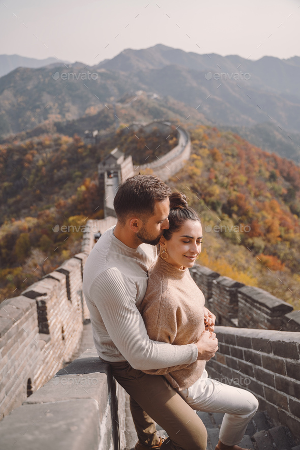 beautiful young couple showing affection on the Great Wall of China - Stock Photo - Images