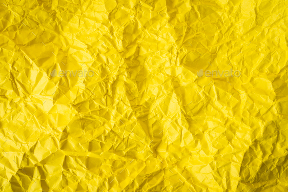 Vivid yellow color crumpled paper texture background Stock Photo