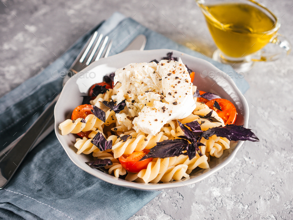 Pasta fusilli with cherry, mozarella and basil - Stock Photo - Images