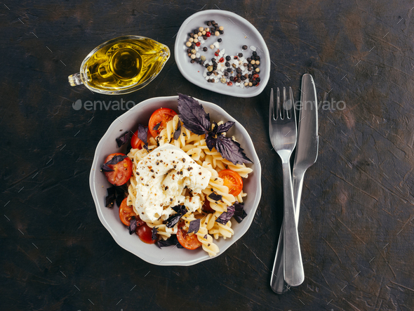Pasta fusilli with cherry, mozarella and basil - Stock Photo - Images