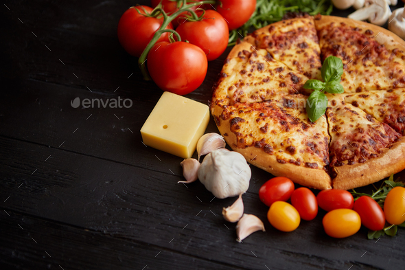 Fresh baked, hot american style pizza with all various ingredients on side - Stock Photo - Images