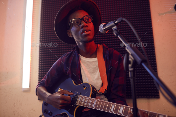 Young African Man Singing in Studio - Stock Photo - Images