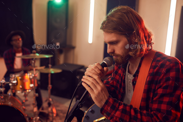 Handsome Young Man Singing in Studio - Stock Photo - Images