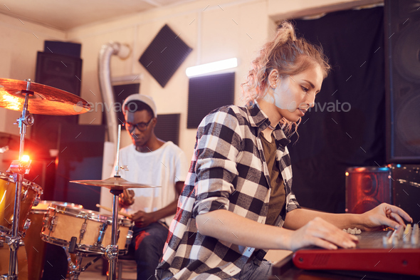 Young Woman Writing Music in Studio