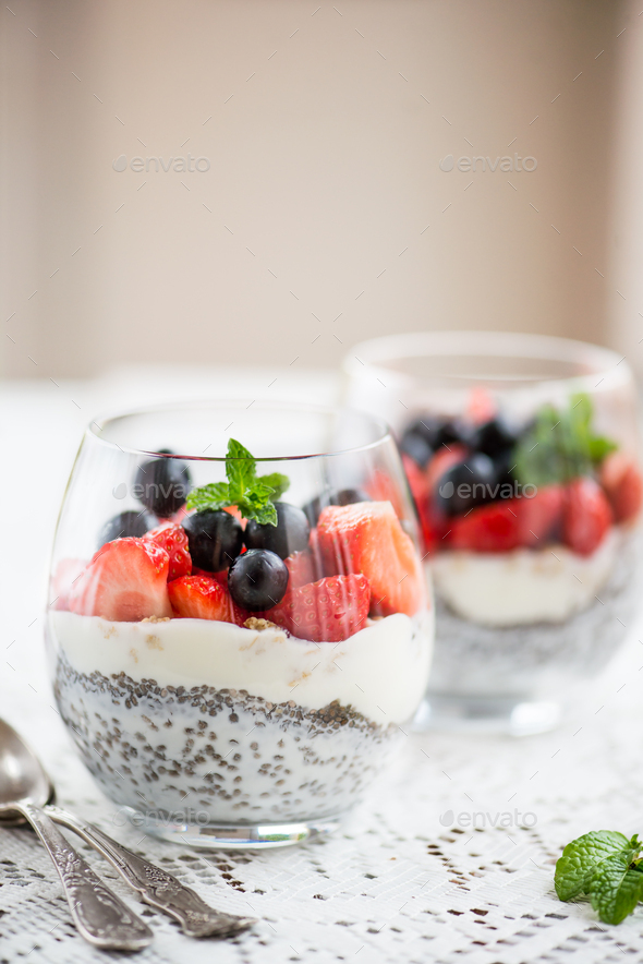 chia seeds in yogurt with granola, yogurt and strawberries, blueberries and mint - Stock Photo - Images