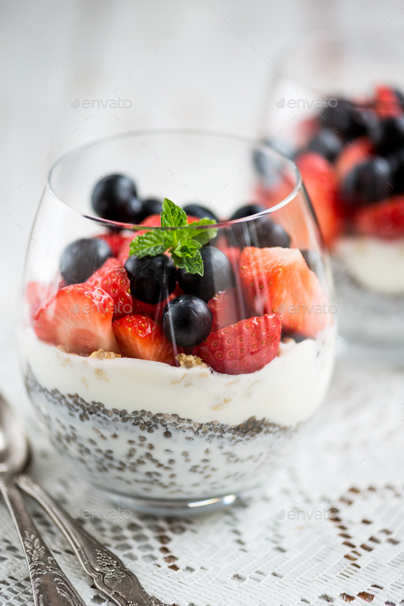 chia seeds in yogurt with granola, yogurt and strawberries, blueberries and mint - Stock Photo - Images