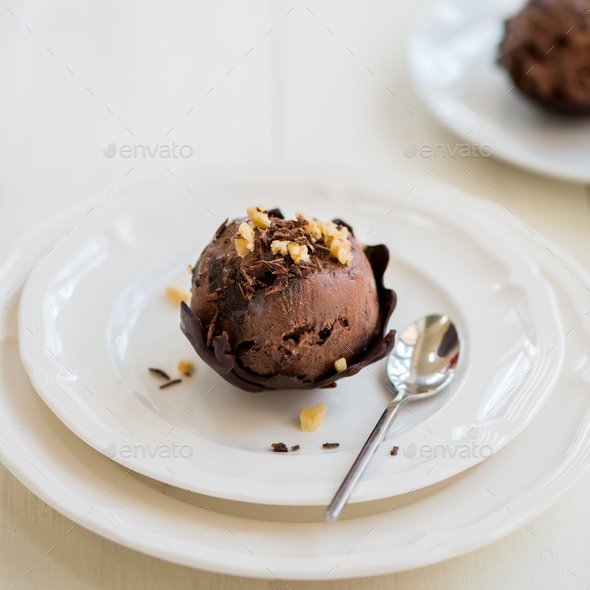 Chocolate Ice Cream Scoop is laying on Chocolate Homemade Bow - Stock Photo - Images