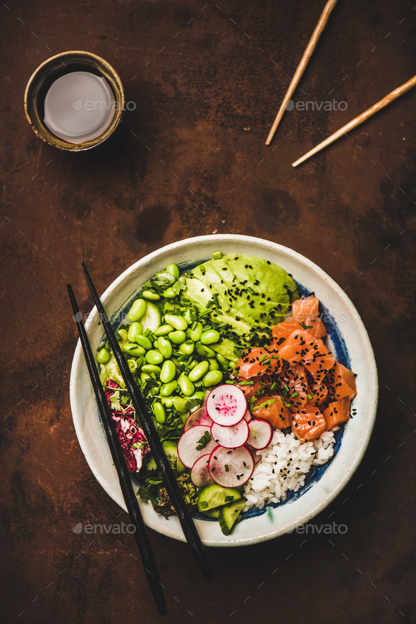 Hawaiian salmon poke bowl with vegetables, greens, rice, soy sauce - Stock Photo - Images