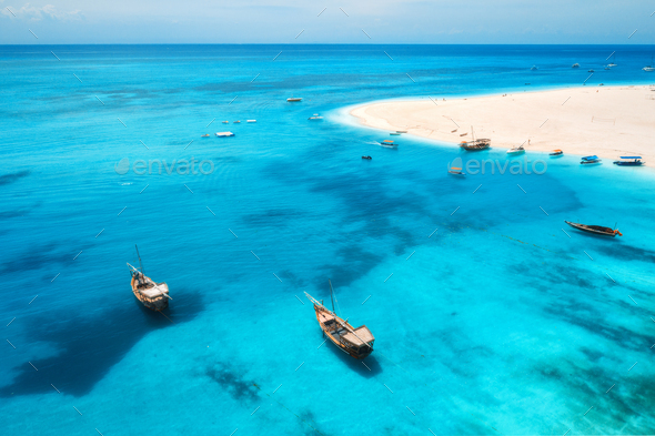Aerial view of boats on tropical sea coast with sandy beach - Stock Photo - Images