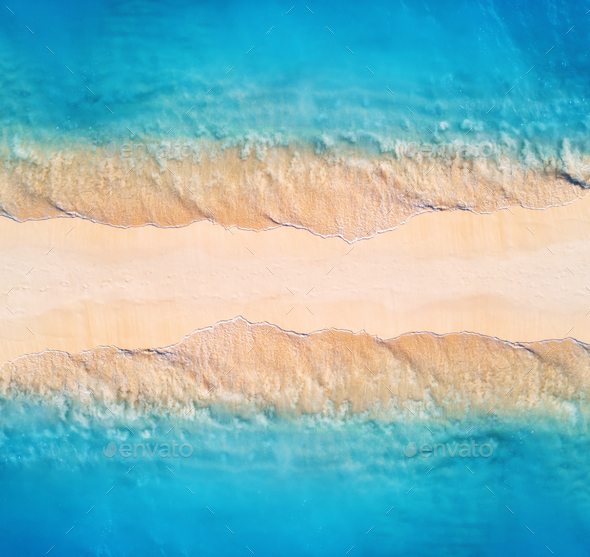 Aerial view of blue sea with waves on the both sides at sunset - Stock Photo - Images