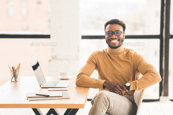Portrait of happy black manager looking at camera