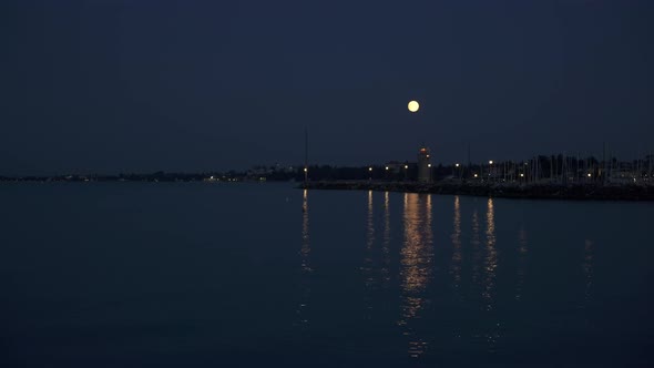 Real Time Wide Shot of the Coast of Lake Garda at Night During the Full Moon