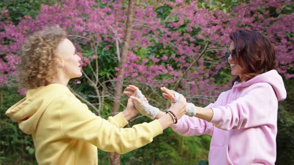 Homosexual Lesbian Couple Hugging in a Sakura Garden alt