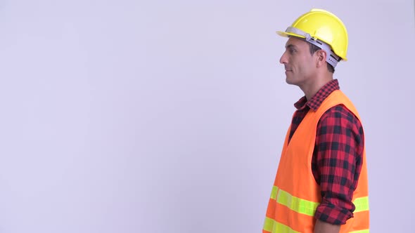 Profile View of Young Happy Hispanic Man Construction Worker Smiling