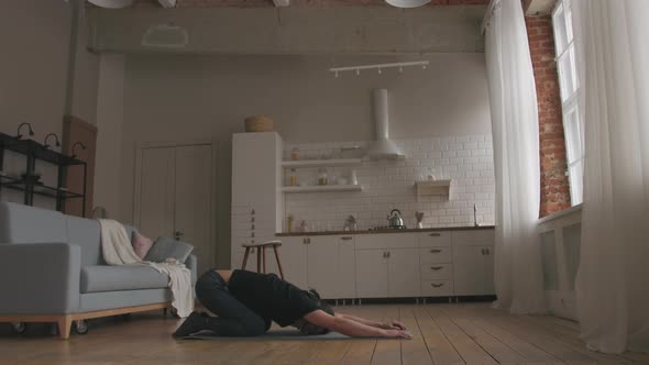 Man Practicing Yoga at home alt