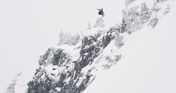 Snowboarding Jump Big Air Trick From Mountain Rock Cliff Into Powder Snow Then Tumble Crash alt