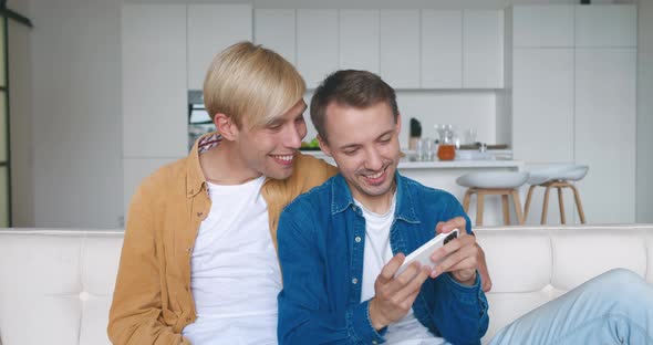 Gambling Males Gay Couple Using Play Mobile Cell Phone Hold Gadget Smartphone Video Pc Games While alt