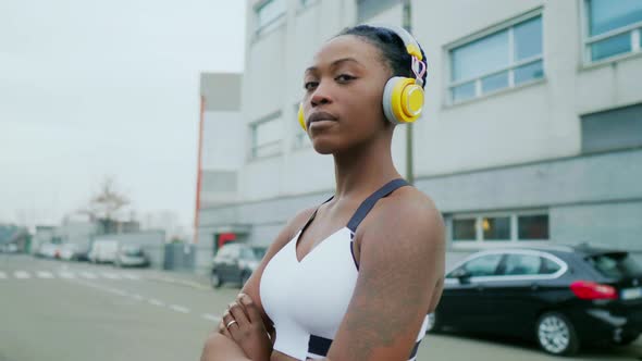 Portrait of young woman with headphones, Milan, Italy