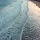 Aerial view of waves crash to shore at sunset - VideoHive Item for Sale