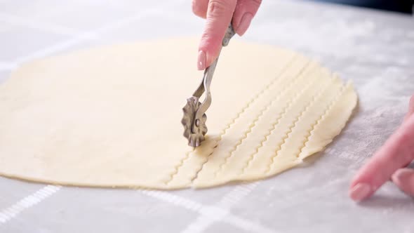 Apple Pie Cake Preparation Series  Woman Slicing Rolled Dough with Rolling Knife alt