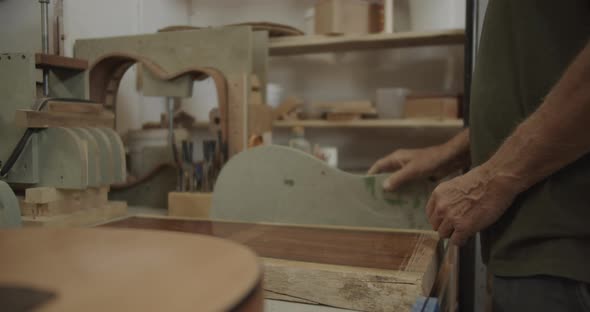 Luthier preparing wooden block to cut