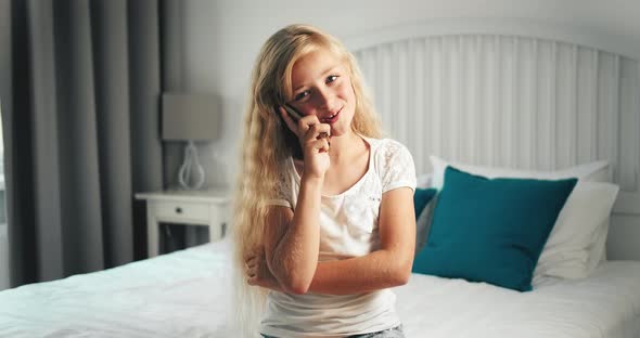 Girl Talking on Smartphone in Bedroom