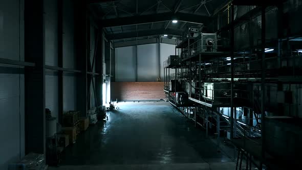 Warehouse with Huge Iron Compressors. Warehouse in the Dark After a Working Day. Huge Dark Shelves