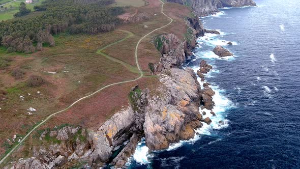 Aerial drone shot of a narrow path over an area called paper cliffs with steep cliffs in Morás, Xove alt