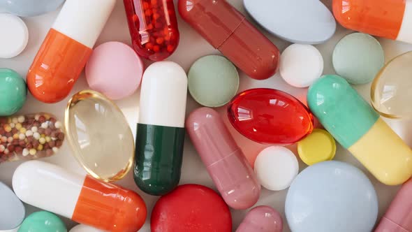 Colorful Medical Pills Oil Capsules Vitamin C Omega 3 Rotating Closeup alt