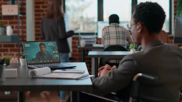 Office Worker in Wheelchair Meeting with Colleague on Videocall alt