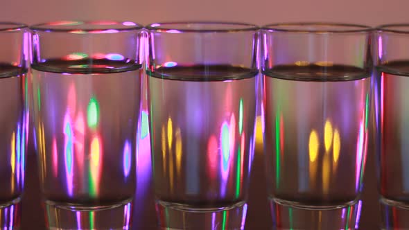 Alcohol Glasses With Party Lamps Background