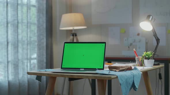 Green Screen Laptop Is On The Table With Fabric And Layout Bond At The Office alt