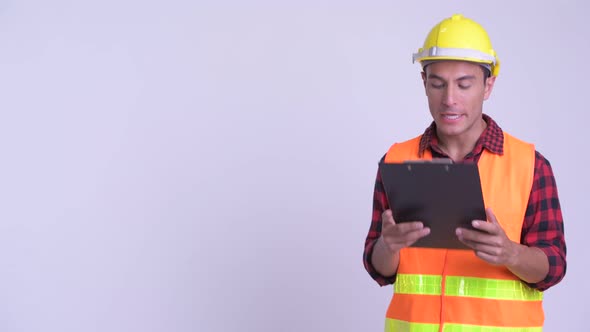 Young Happy Hispanic Man Construction Worker Presenting with Blackboard and Clipboard